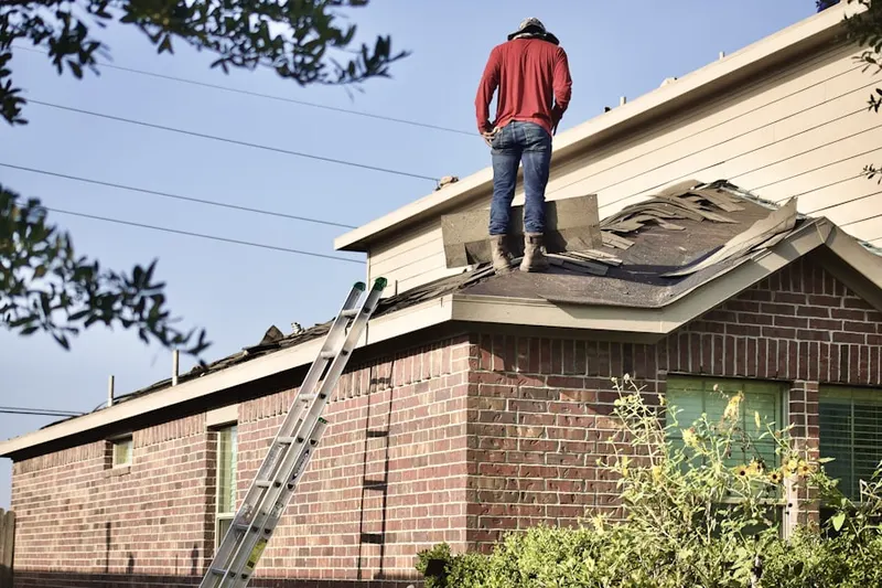 Professional roofer working on a residential roof in Barto